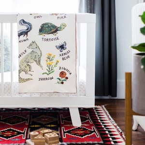 baby blanket laying on crib